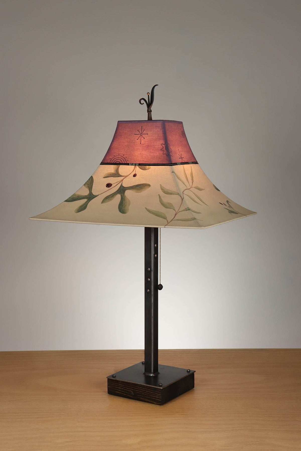 Janna Ugone &amp; Co Table Lamp Steel Table Lamp on Wood with Large Pagoda Shade in Mixed Leaves in Buff and Grape